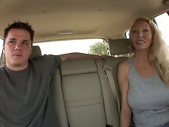 Blonde MILF with juicy tits sucks guy's tool in the car