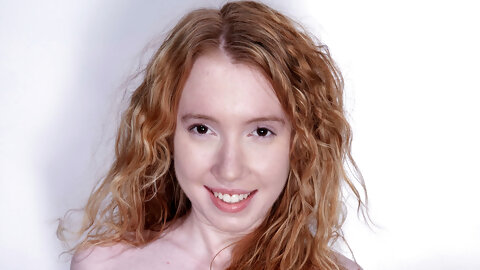 Petite curly haired redhead Nicki Blue flaunts her bush on a fitness ball