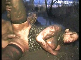 Creepy dude fucks sexy brunette in the mud on a field