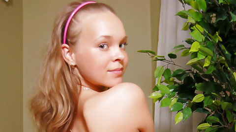 Young looking girl Bella D gets butt naked on a chesterfield